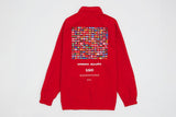 Back image of red nylon 1/4 zip pullover with screen printed image of 195 flags from countries of the world text underneath graphic reads ' Umbro , Akomplice 195 there are over 7 billion people living in 195 countries on this planet. World peace is an individual and collective responsibility'.