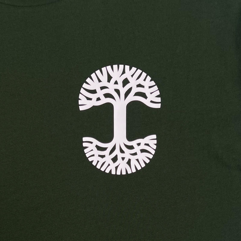 Detailed close up image of Forest tee with white(to start) UV activated Oaklandish tree logo on wearer's left chest.