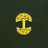 Detailed close up image of Forest tee with yellow UV activated Oaklandish tree logo on wearer's left chest.
