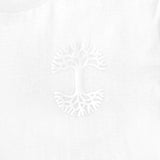 Detailed close up image of white tee with white(to start) UV activated Oaklandish tree logo on wearer's left chest.