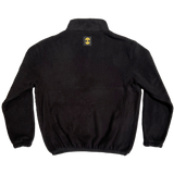 The backside of a black polar fleece pullover with a yellow Oaklandish tree logo patch under the collar.