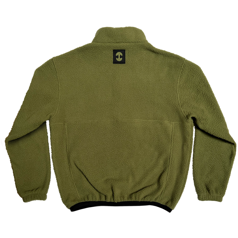 The backside of a green polar fleece pullover with a black satin logo patch with a green Oaklandish tree logo under the collar.
