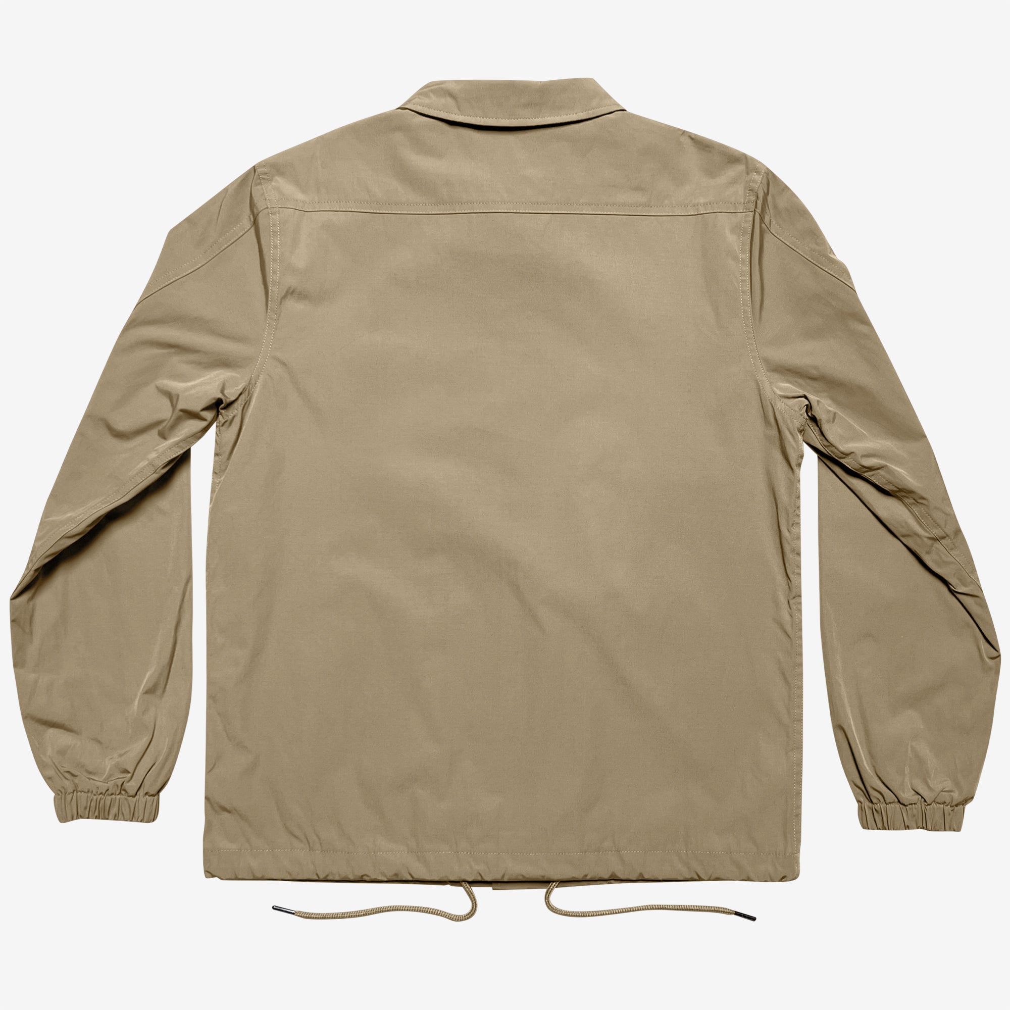 The Oaklandish Premium Coaches Jacket in khaki is showcased from the back, highlighting its simple collar, long sleeves with elasticated cuffs, and a straight hem. A drawstring is visible at the bottom hem. This water-resistant jacket boasts a clean, minimalist design without any visible logos or embellishments. Designed in men's sizing.