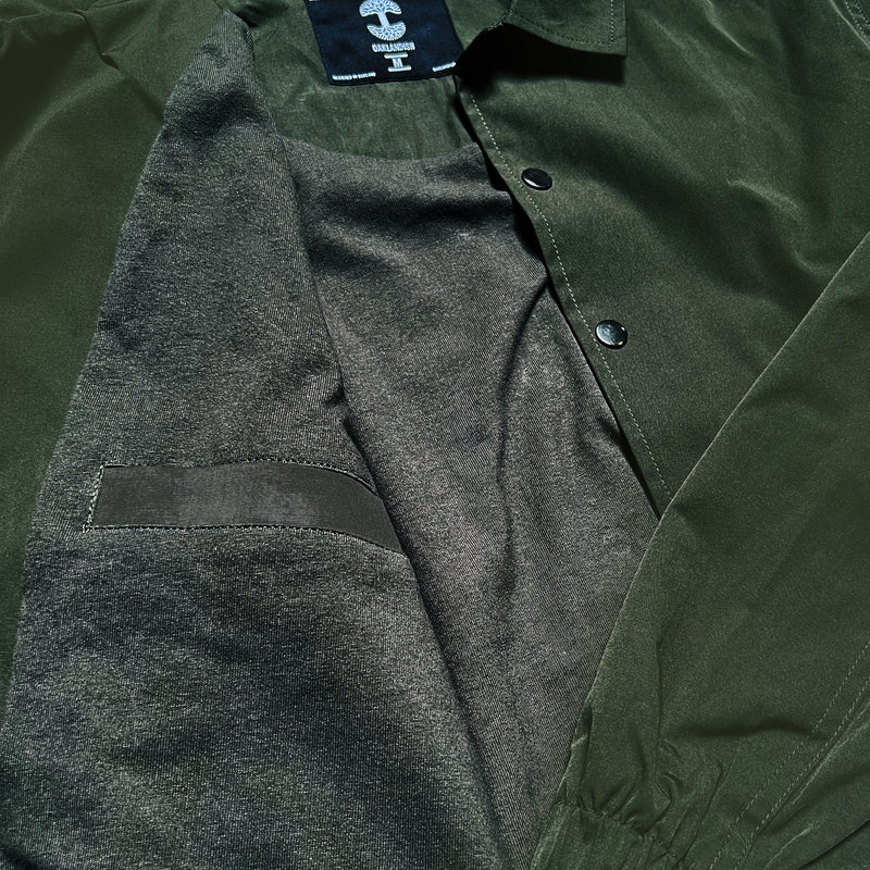 View of inside pocket on olive green snap close cotton jacket.