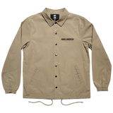 Khaki snap close coaches jacket with 'Oaklandish' wordmark on the wearer's left chest, with a collar and drawstring waist.