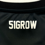 Detail close up image of '51GROW' wordmark lockertag in white on black jersey.