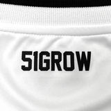 Detail close up image of '51GROW' wordmark lockertag in black on white jersey.