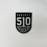 Detail close up of Project 510 crest on wearer's left chest of white Jersey,'