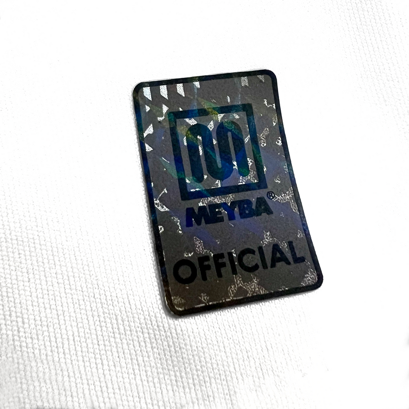 Detail close up of Meyba logo at hem of white Project 510 x Meyba Jersey.