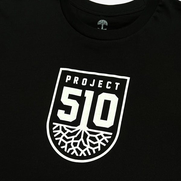 Close up on a white 510 Oakland SC Roots logo on the chest of a black t-shirt.