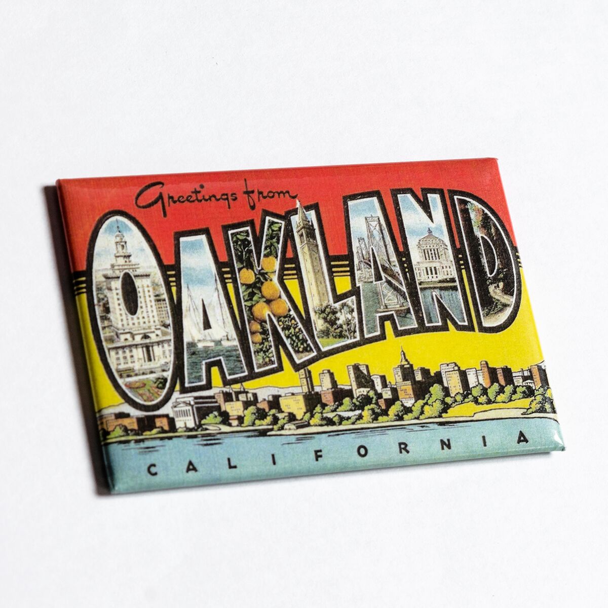 Full color, red, blue, yellow with black lettering, “Greetings for Oakland, California” postcard style magnet.