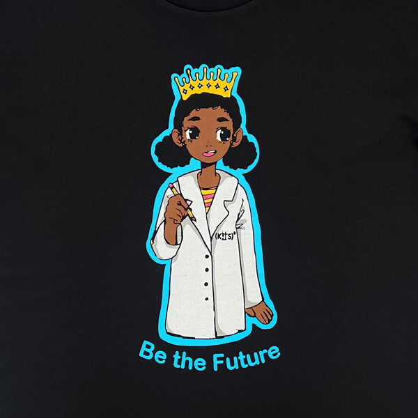 Close-up of a crowned Royal Scientist girl dressed as a scientist and a “Be The Future” wordmark on a black t-shirt.