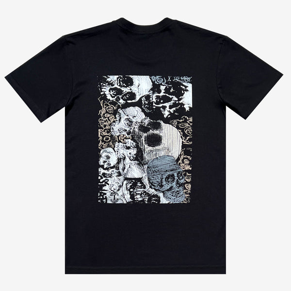 Back side of a black t-shirt with a graphic image of several white and grey skulls.