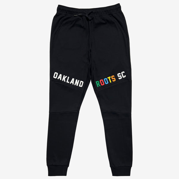 Black joggers with white OAKLAND wordmark on right leg and color Roots SC wordmark on the left leg.