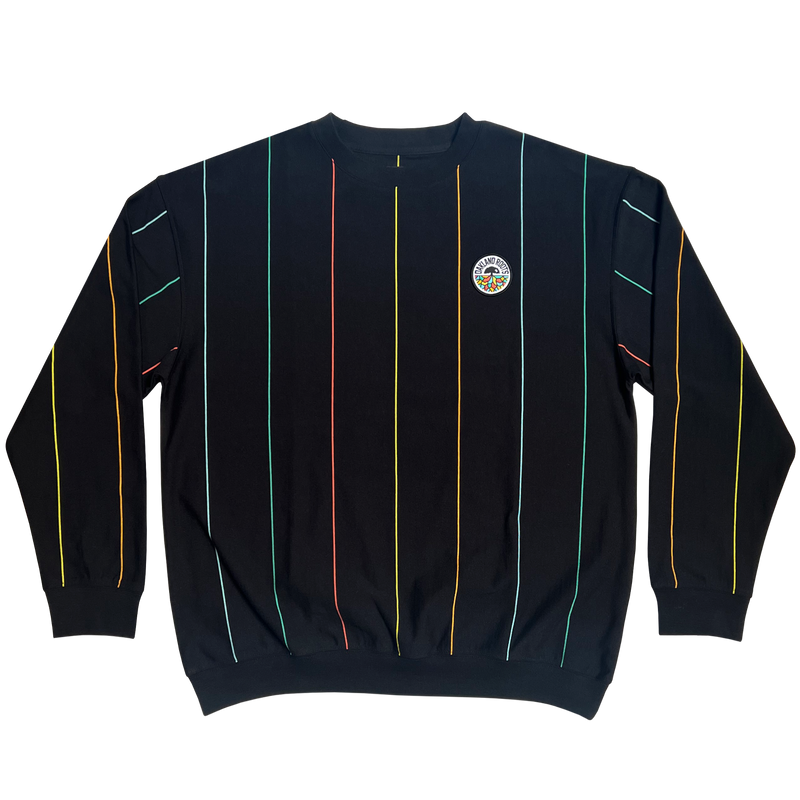 Flat lay of a black crewneck sweatshirt with multicolor pinstripes and Oakland Roots SC crest on wearer's left chest.