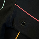 Detailed close-up of underarm gromets on a black crewneck sweatshirt with multicolor pinstripes and Oakland Roots SC crest on wearer's left chest.