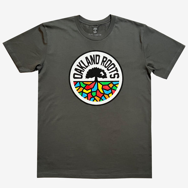 Charcoal grey t-shirt with full-color, round Oakland Roots logo on the chest.