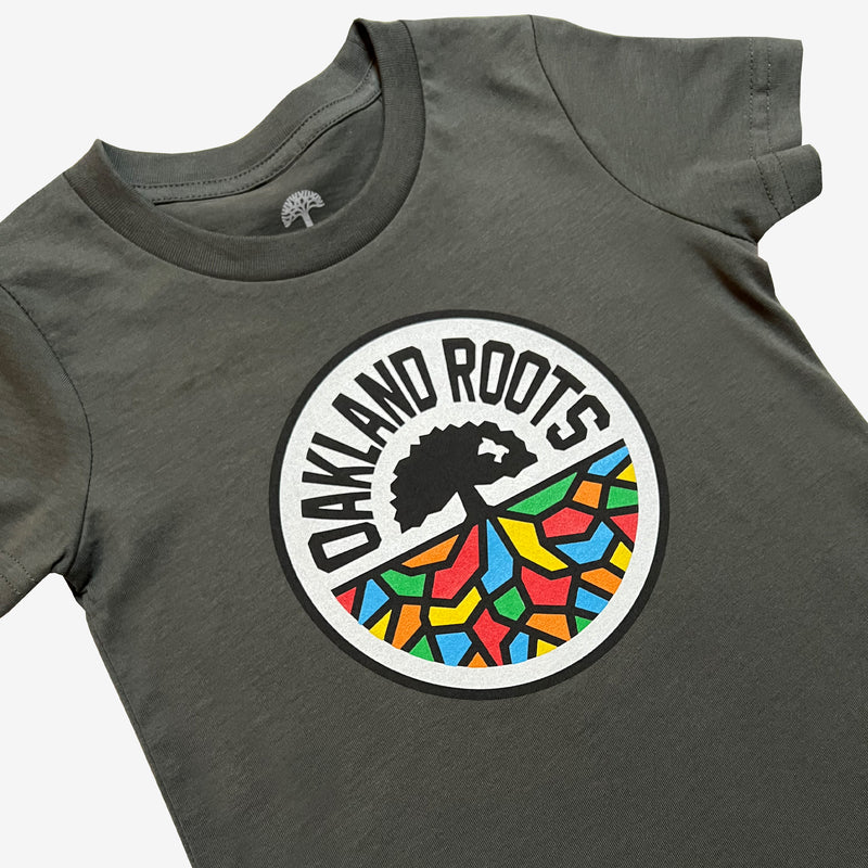 Close up of charcoal grey toddler-sized t-shirt with a full-color Roots SC logo on the chest.