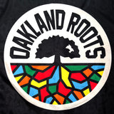 Detailed photo of round Oakland Roots crest logo on the flag.