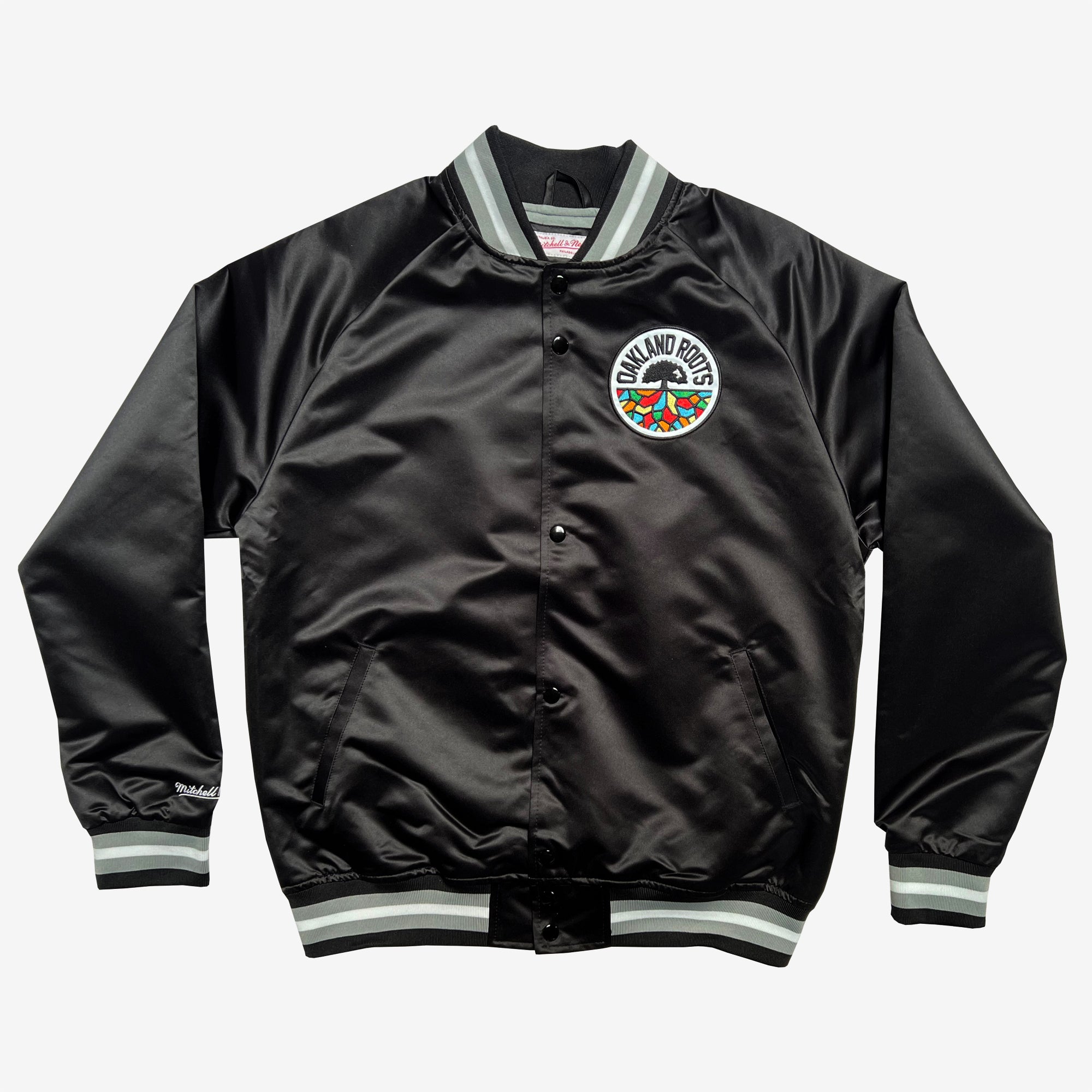 Black satin jacket with striped collar, sleeve cuffs, bottom trim, button closures, front pockets, and round Roots SC logo patch.