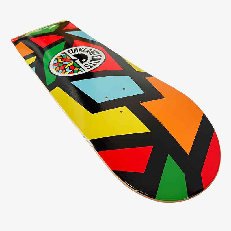 Detailed close-up of the underside of skateboard deck with full-color Roots Soccer Club mosaic colors and round logo mark.