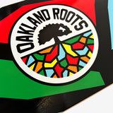 Detailed close-up of full-color Roots Soccer Club mosaic round logo on a skateboard deck.