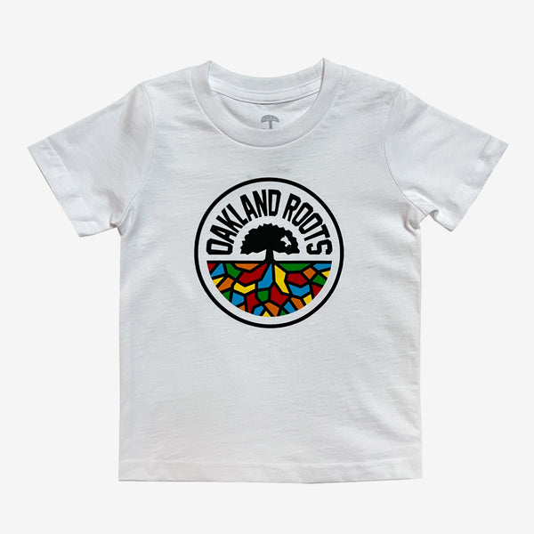 White toddler-sized t-shirt with a full-color Roots SC logo on the chest.