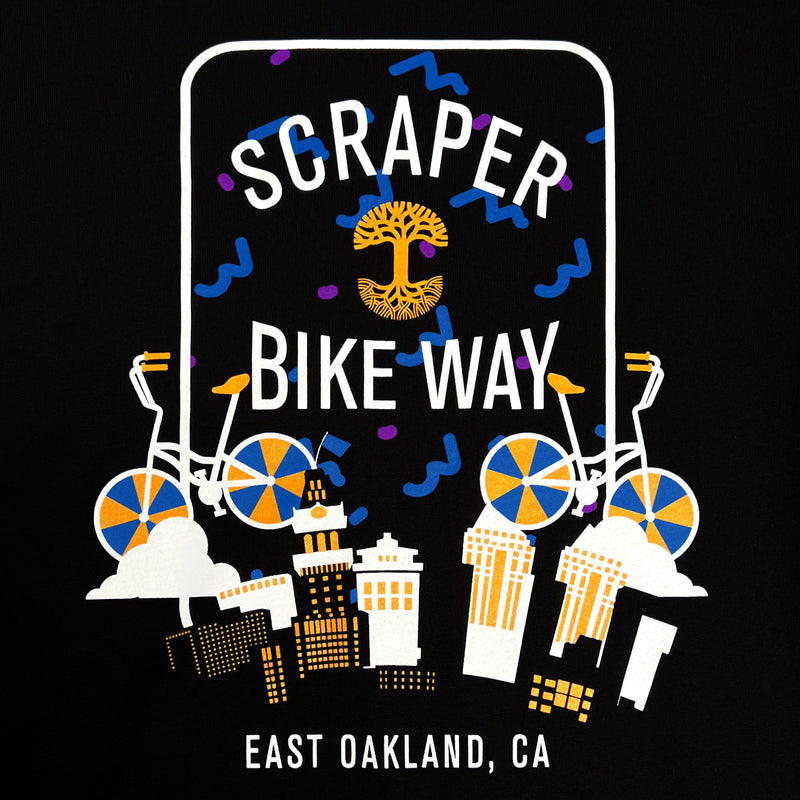 Detailed close up of white, blue, yellow Scraper Bike Way graphic & East Oakland wordmark on a black t-tshirt.