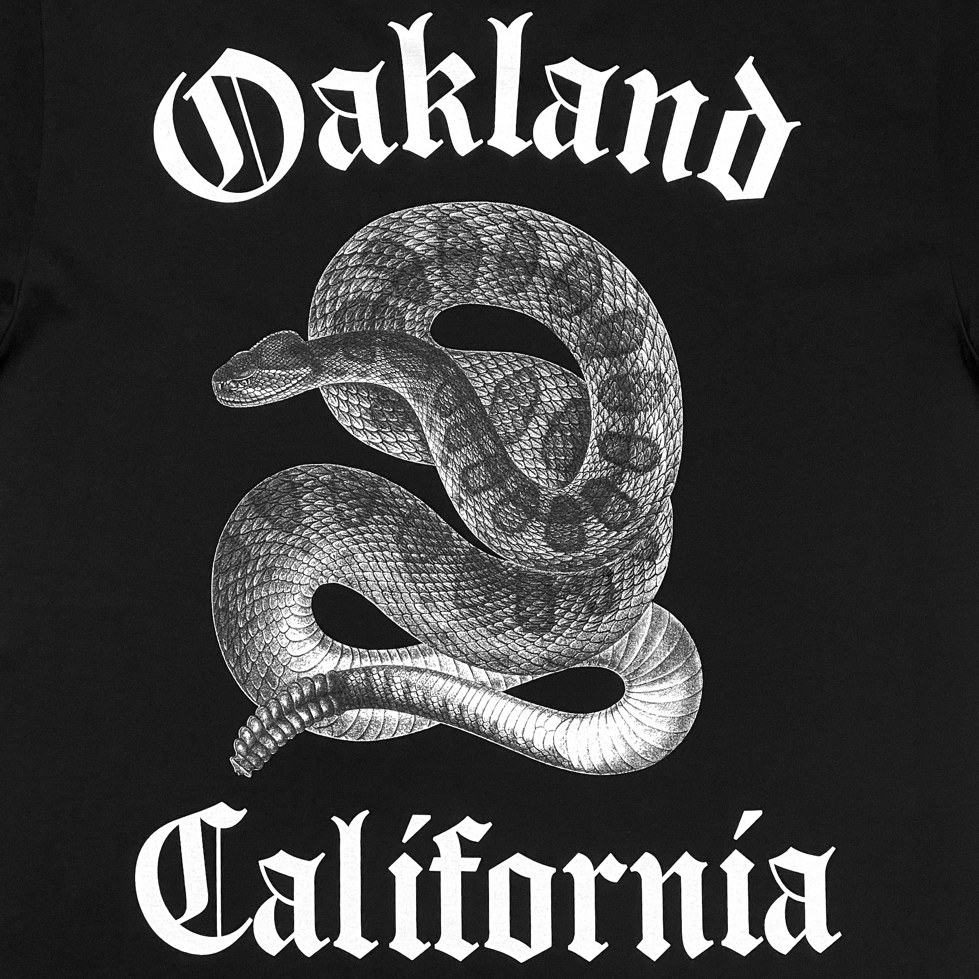 Detailed  close up back image of men's black t-shirt with detailed snake graphic between 'Oakland California'.