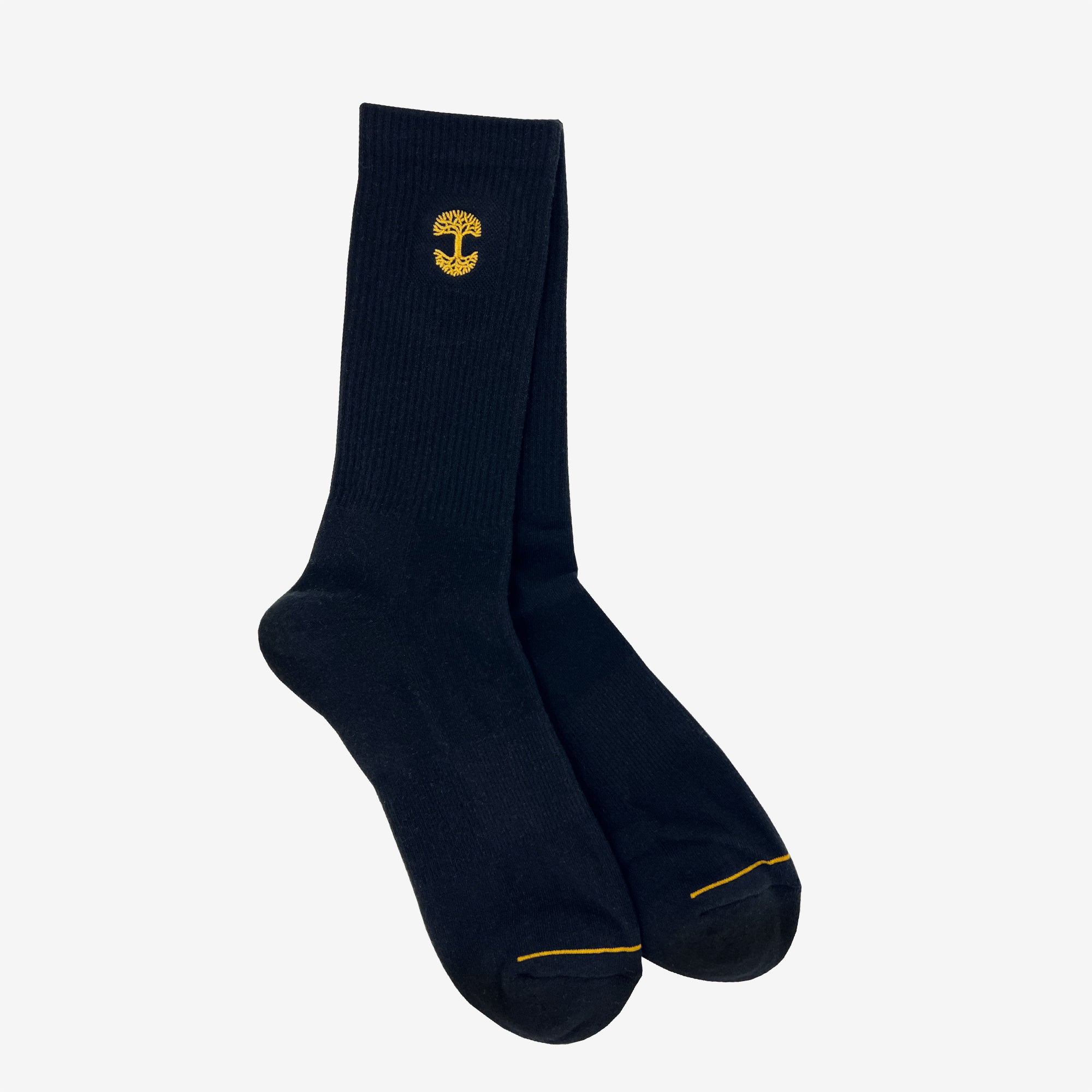 Two nestled high-cut black crew socks with an embroidered gold Oaklandish logo at the top.