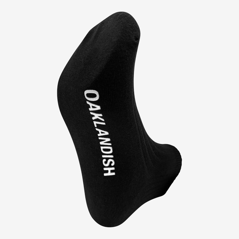 Men's Crew Socks in black. Sole angle with Oaklandish text in white across sole.
