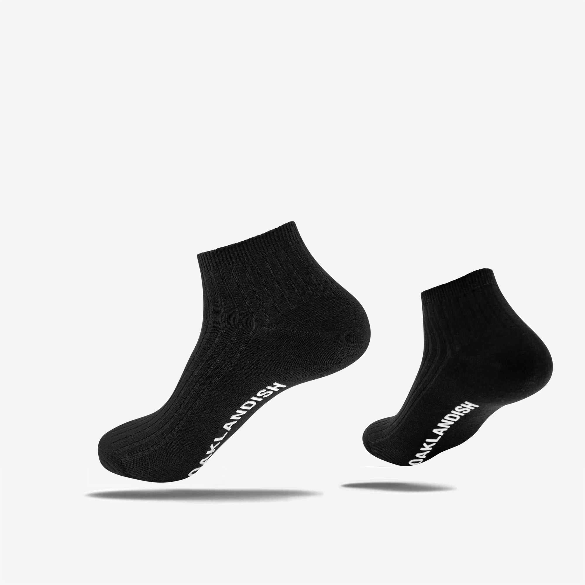 Low-cut slate black crew socks with a white Oaklandish wordmark on the sole.