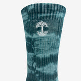  Close up of an embroidered Oak logo detail on a high-cut light and dark blue crew sock.
