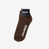 Low-cut crew socks in Oaklandish package, in slate brown with white Oaklandish wordmark on the sole.