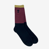 Two nestled high-cut, color-blocked (black, maroon, and brown) crew socks with an embroidered Oak logo detail.