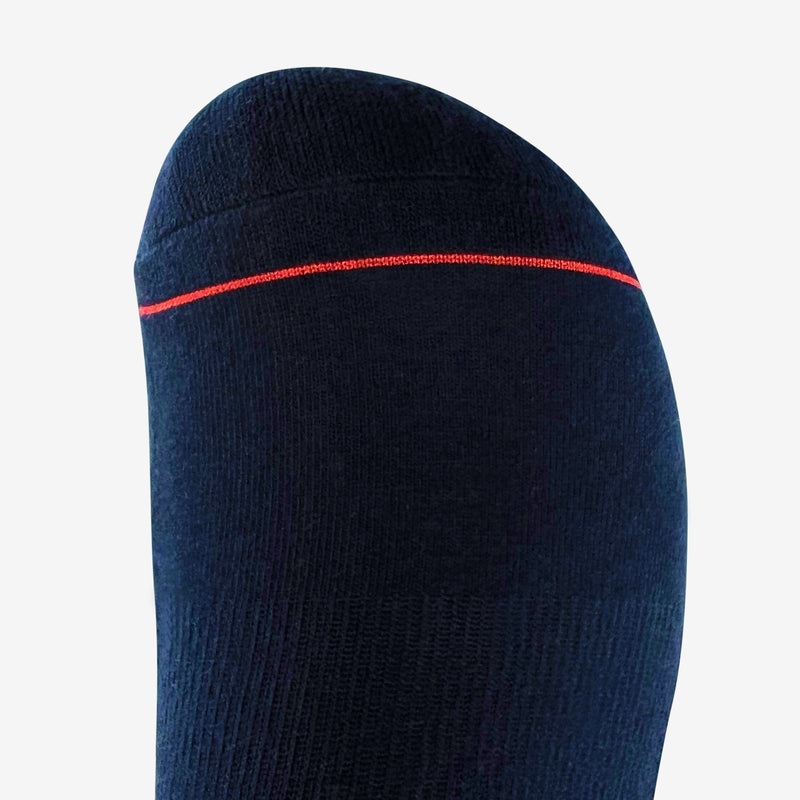 Close up of red stripe on the toe of navy crew socks.