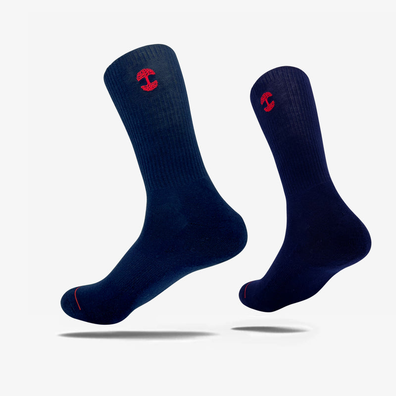 High-cut men's navy crew socks with red embroidered Oaklandish logo at the top.