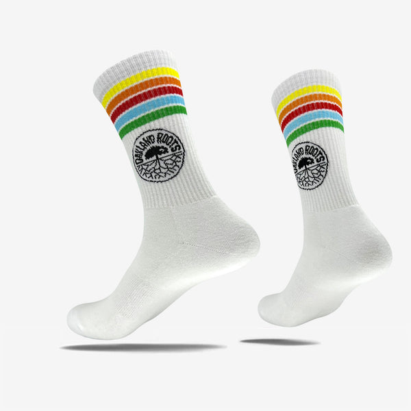White crew socks with Oakland Roots Soccer Club colored stripes & logo on top sides. 