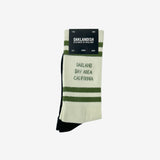 White socks with Oakland Bay Area California in capital letters folded in Oaklandish retail packaging.