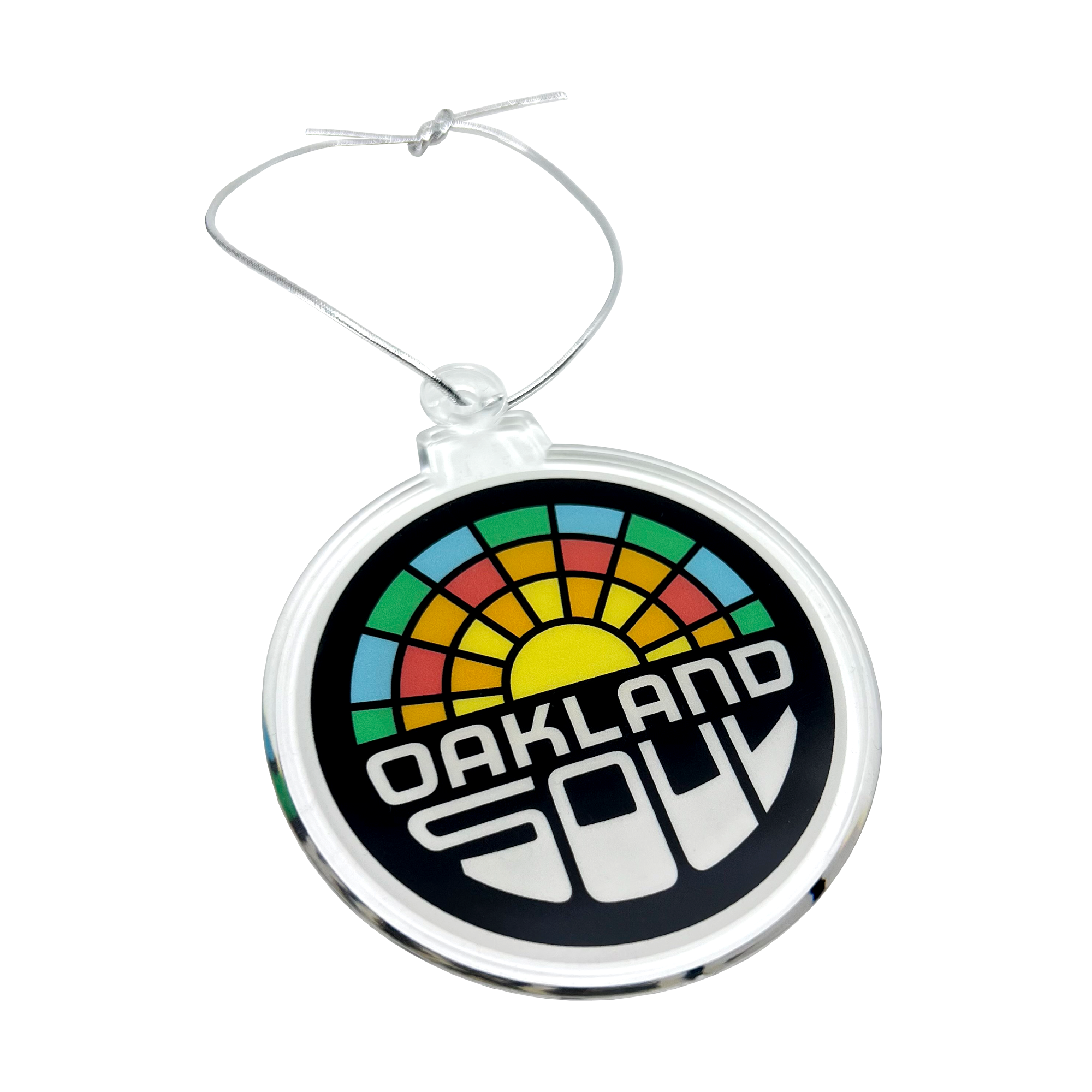 Side view of full-color Oakland soul crest  on a holiday tree ornament with silver string.