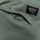 Detail close up of army standard sweatpants woven label above right back zipper pocket.