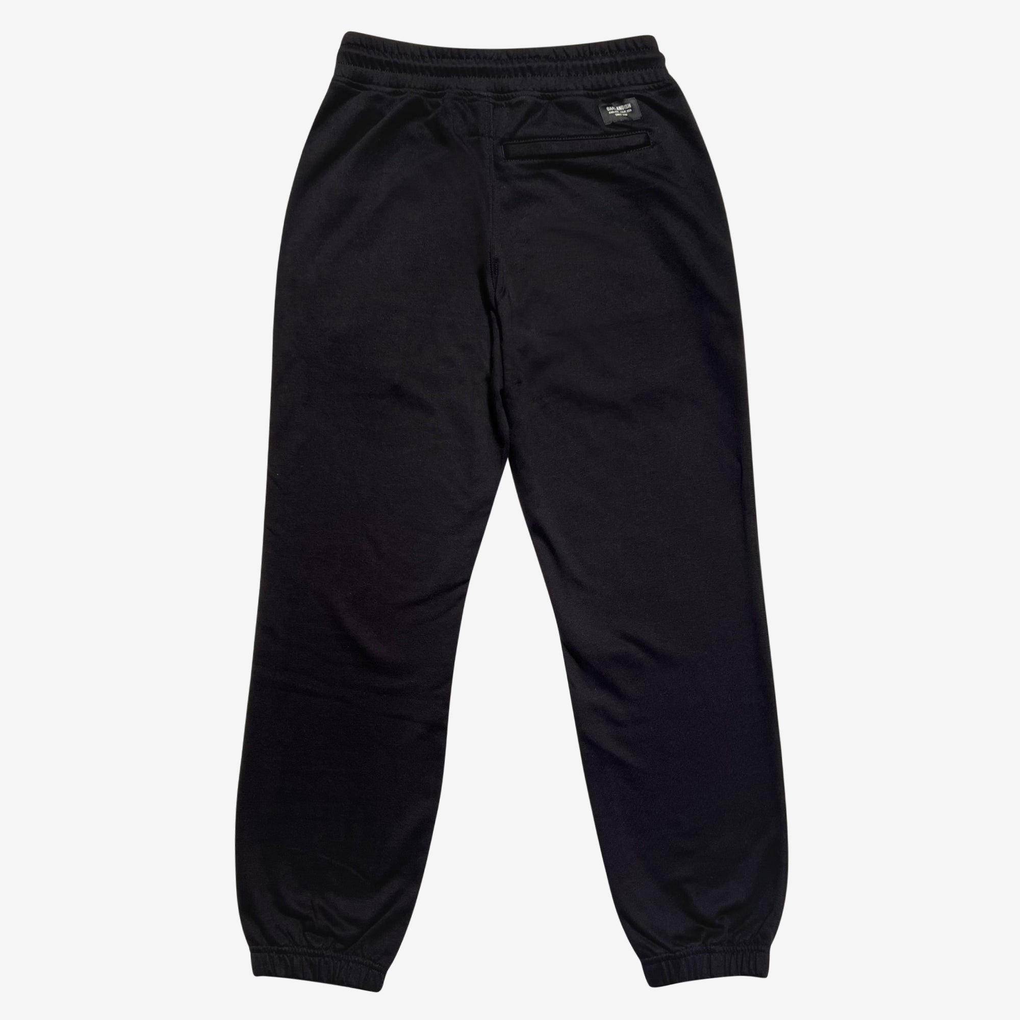 The backside of black Oaklandish joggers with a zipped pocket on the left wear side. 