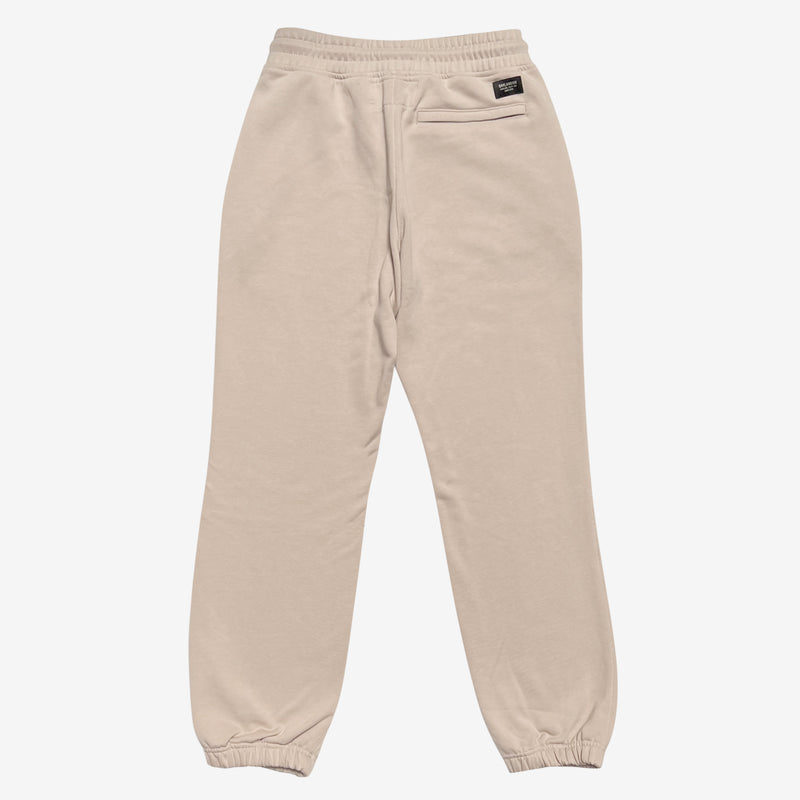 The backside of sand colored Oaklandish joggers with a zipped pocket on the left wear side. 