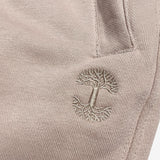 Detail close up of of sand standard sweatpants tree logo embroidery .