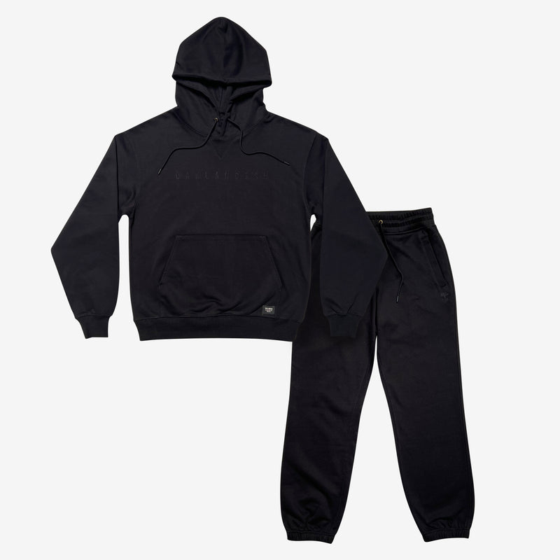 Black hoodie and jogger set with Oaklandish wordmark embroidered on hoodie chest and Oaklandish tree logo under left front jogger pocket.
