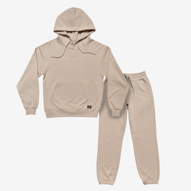 Sand-colored hoodie and jogger set with Oaklandish wordmark embroidered on chest of hoodie.