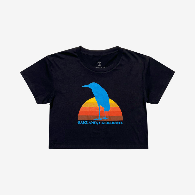 Women's cropped black t-shirt with Sun Heron graphic & Oakland California wordmark.