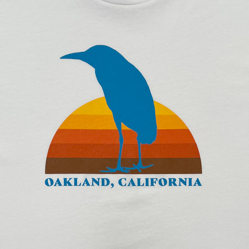 Close up of Sun Heron graphic Oakland California on white t-shirt.