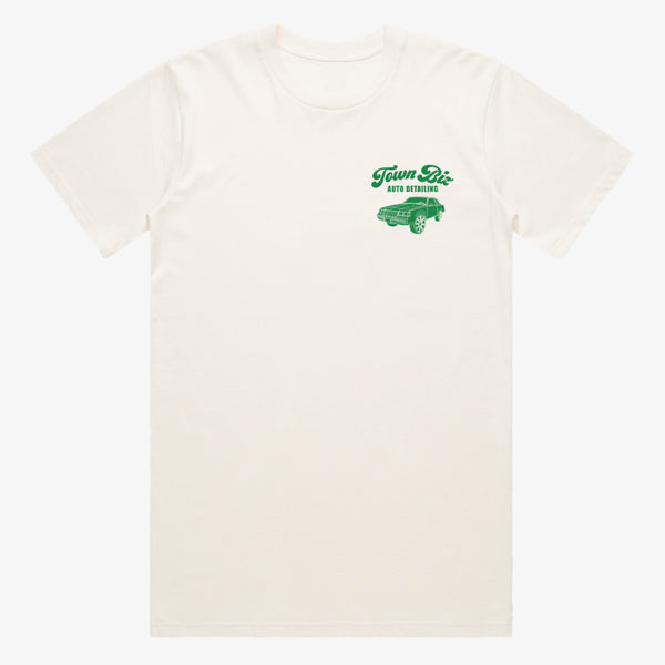 Creme t-shirt with green Town Biz Auto dealing wordmark and car on left wear side chest.