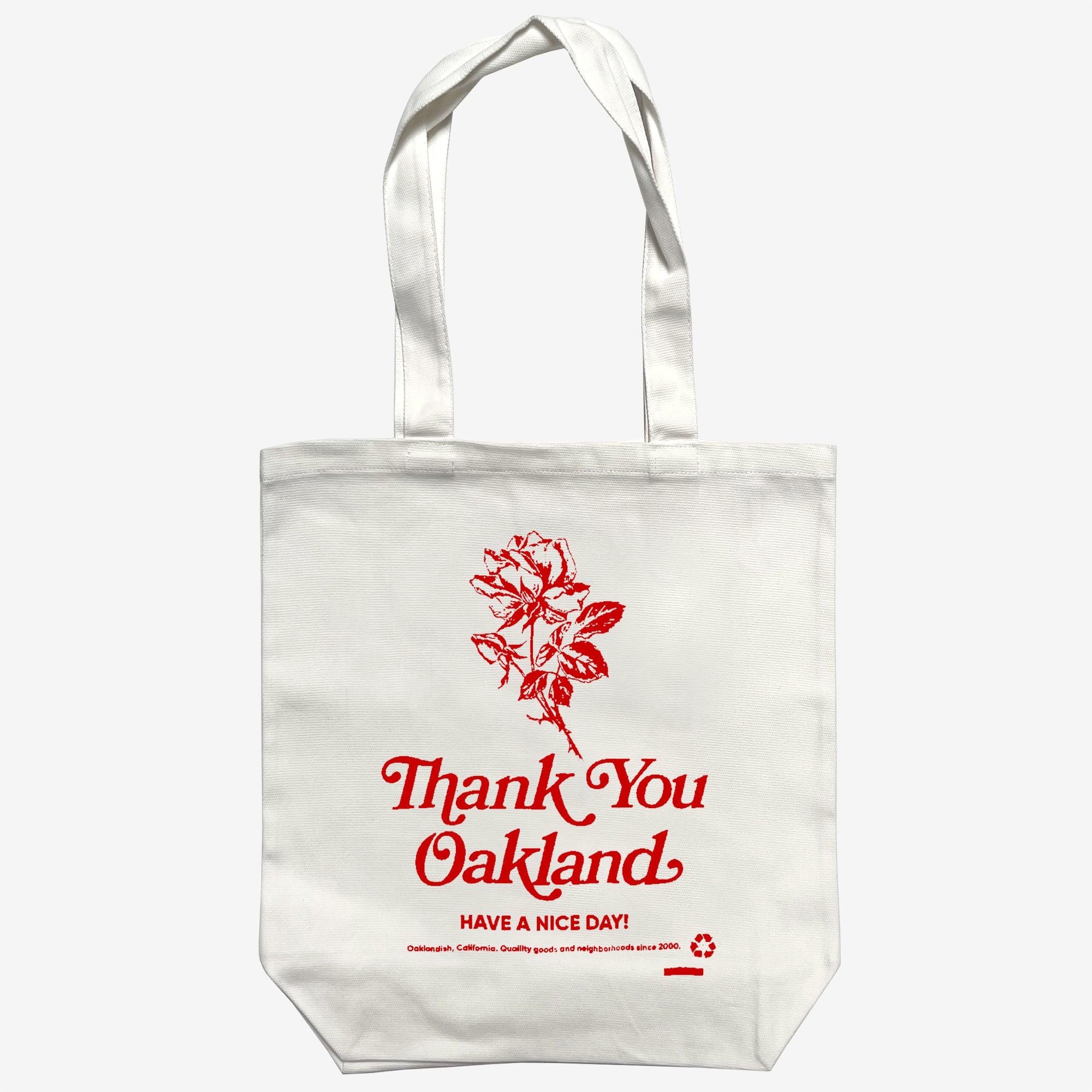 Cream shopping tote bag with hand-drawn red flower and the words “Thank-You Oakland. Have a Nice Day”.